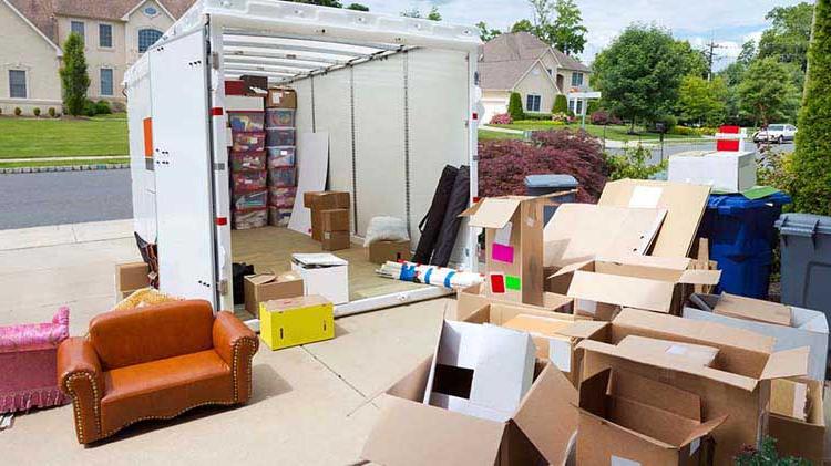 Moving container in a driveway with boxes