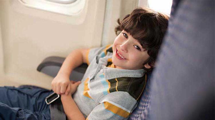 Child riding safely in an airplane for the first time.